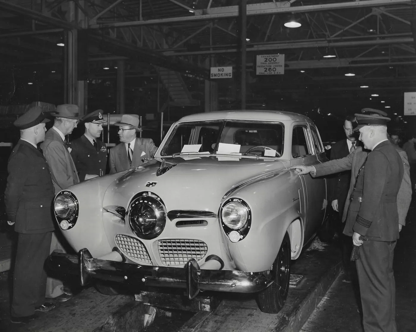 Vice President Gus Gaskin showing off the new 1950 Studebakers to RCAF Officers as they get off the Assembly Line